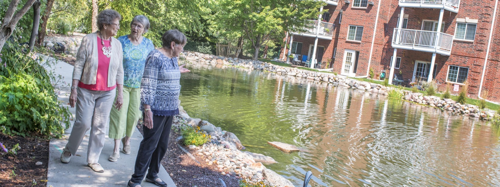 women walking around pond